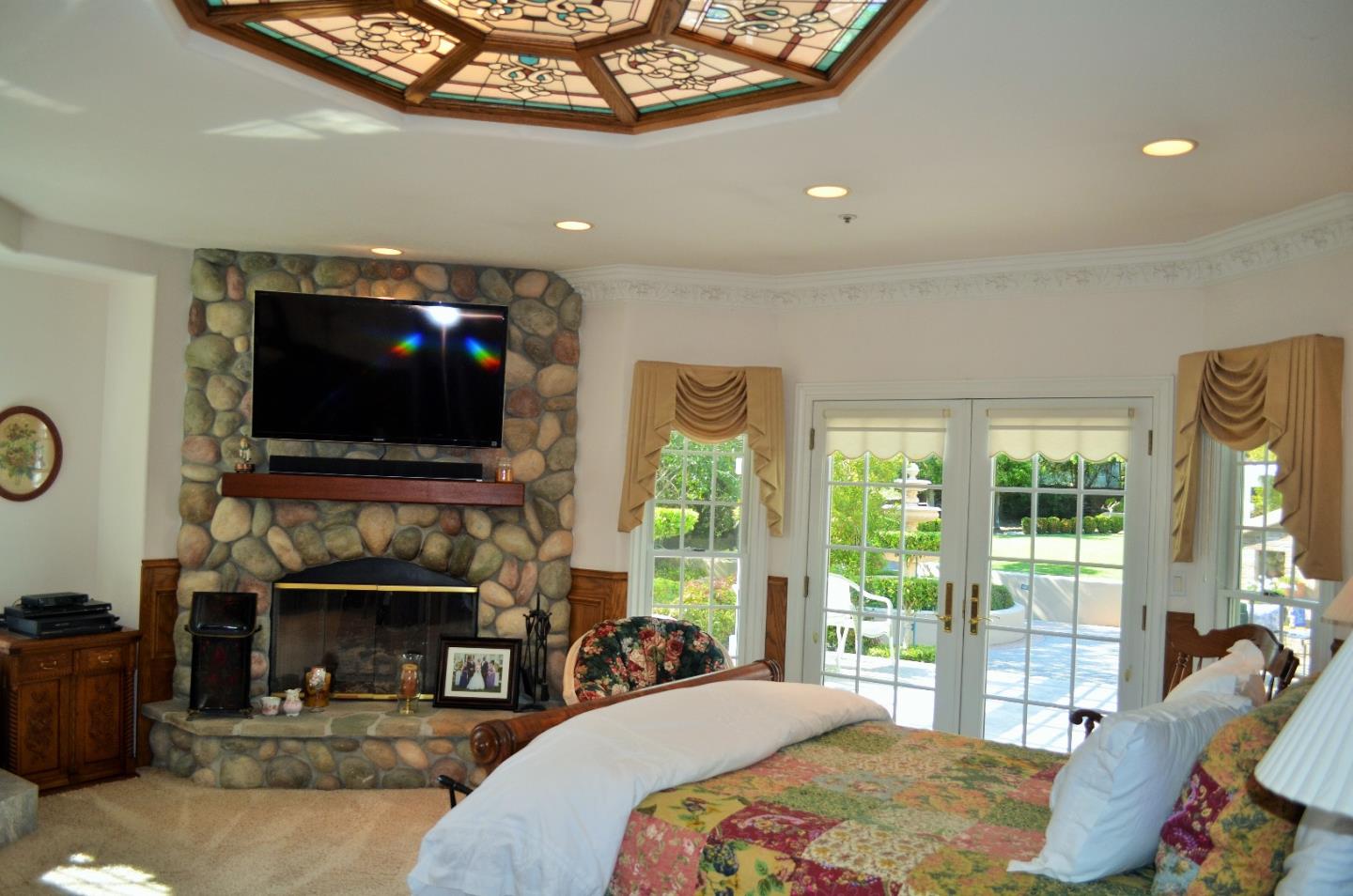 385 Tolak Road Aptos, CA 95003 - Photo 37 of 82 a bedroom with furniture a flat screen tv and a fireplace