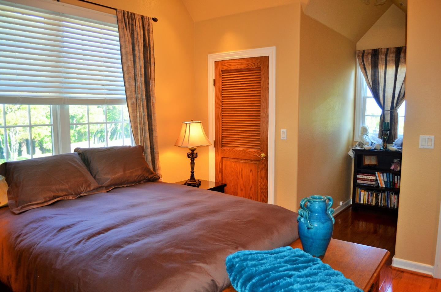 385 Tolak Road Aptos, CA 95003 - Photo 50 of 82 a bedroom with a bed and wooden floor