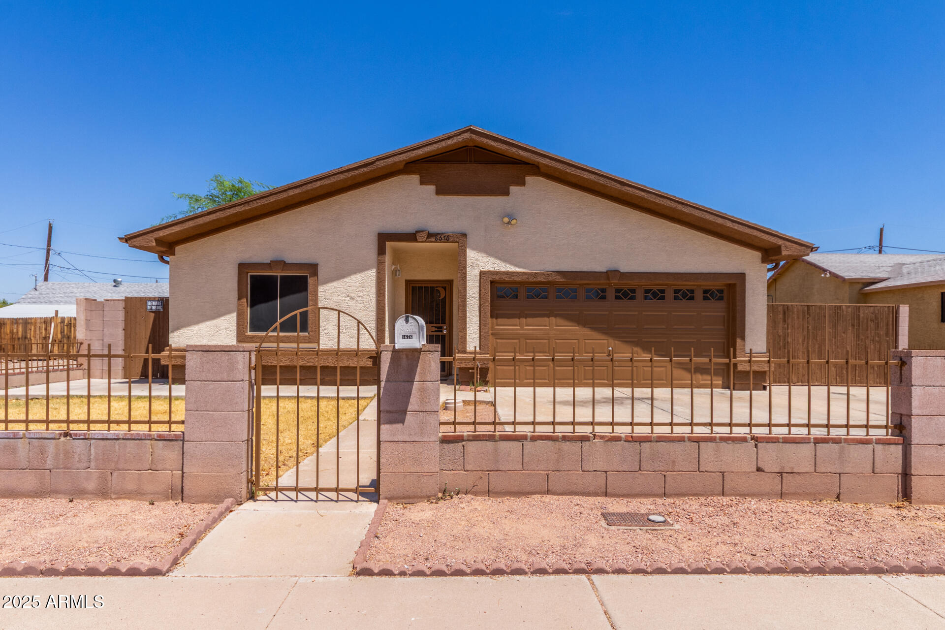 a view of a house with wooden fence