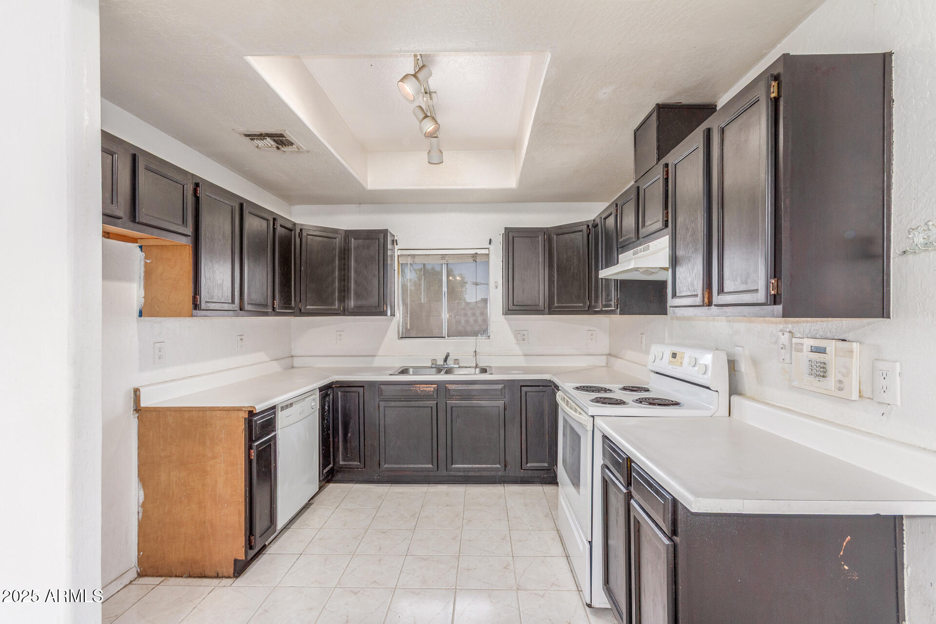 8676 West Mountain View Road Peoria, AZ 85345 - Photo 13 of 33 a kitchen with stainless steel appliances granite countertop a sink stove and cabinets