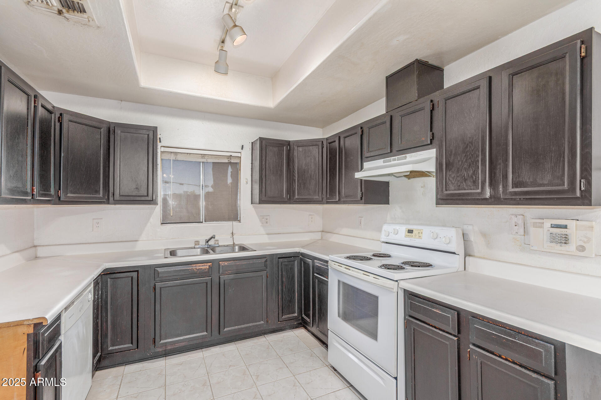 8676 West Mountain View Road Peoria, AZ 85345 - Photo 14 of 33 a kitchen with a sink stove and cabinets