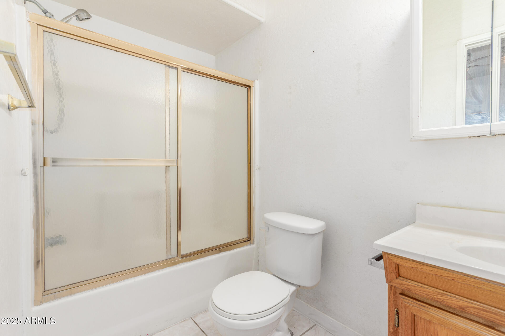8676 West Mountain View Road Peoria, AZ 85345 - Photo 20 of 33 a white toilet sitting next to a bathroom sink