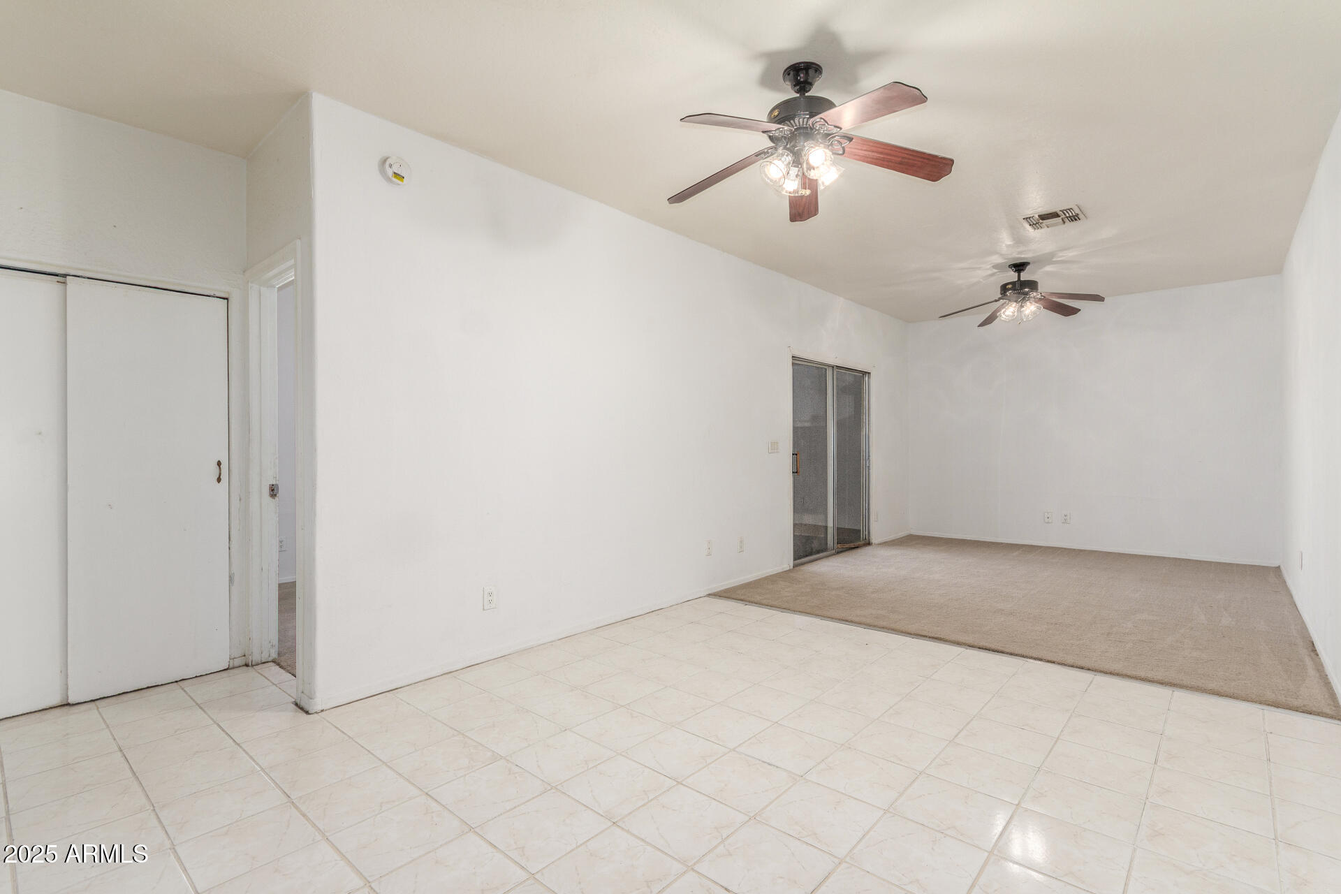 8676 West Mountain View Road Peoria, AZ 85345 - Photo 9 of 33 an empty room with chandelier fan and windows