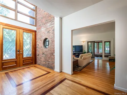 a bedroom with furniture and a large window