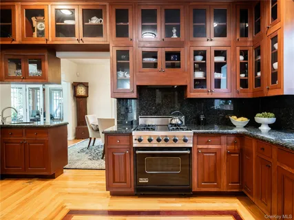 a kitchen with stainless steel appliances granite countertop a stove top oven