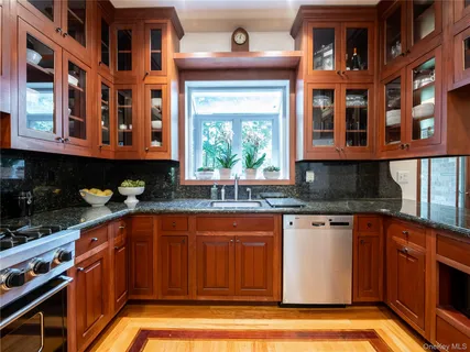 a kitchen with stainless steel appliances granite countertop a stove and a sink