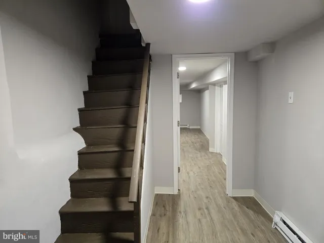 a view of entryway and gallery with wooden floor