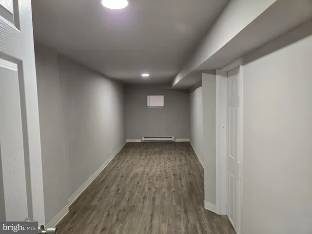 a view of a room with wooden floor and window