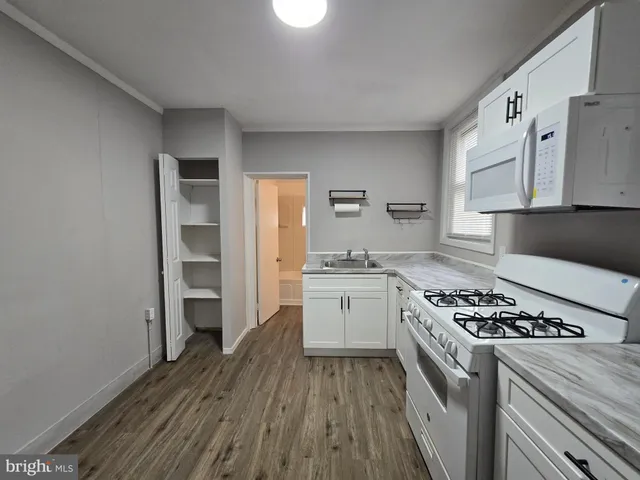 a kitchen with a stove a sink and a refrigerator