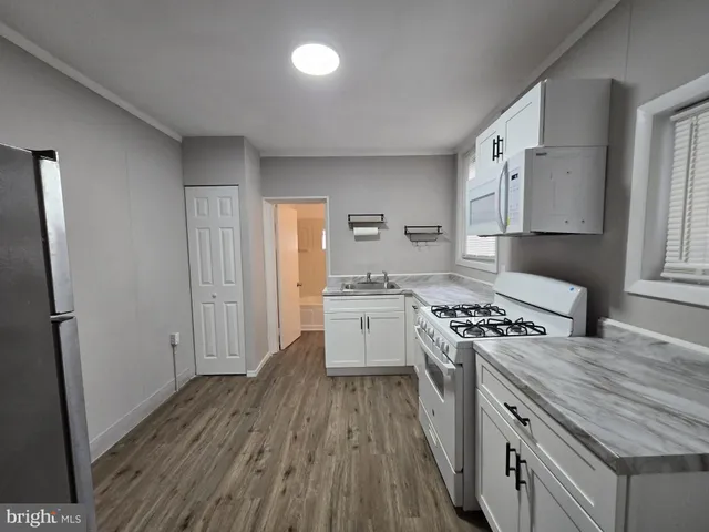 a kitchen with a stove a sink and a refrigerator