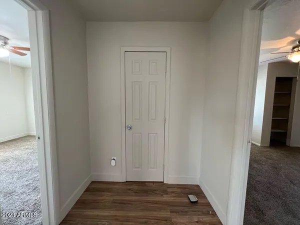 a view of a hallway with wooden floor
