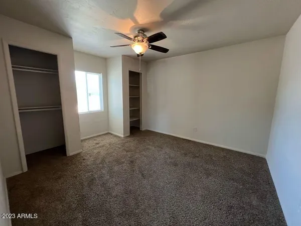 a view of a livingroom with a ceiling fan and window