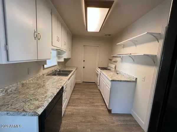 a kitchen with a sink stove and cabinets