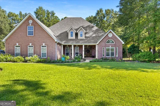 a front view of a house with a yard