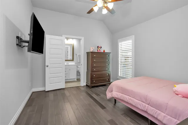 a bathroom with a sink vanity mirror and toilet
