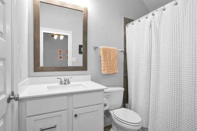 a kitchen with a refrigerator a sink dishwasher a stove and white cabinets with wooden floor