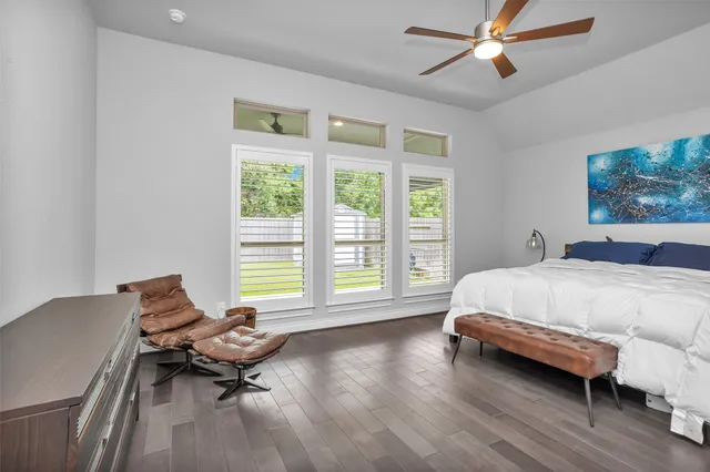 a spacious bedroom with a bed and a window