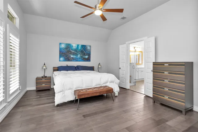 a bathroom with a double vanity sink a toilet a mirror and