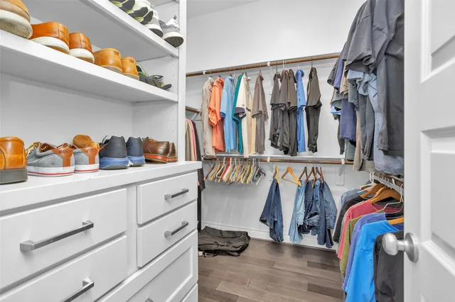 a view of walk in closet with clothes