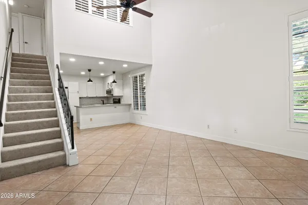 a view of a kitchen with furniture and staircase