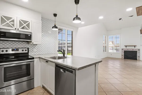 a kitchen with granite countertop a stove and a sink