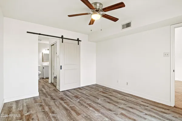 a view of empty room with wooden floor