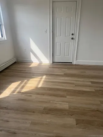 a view of a room with wooden floor
