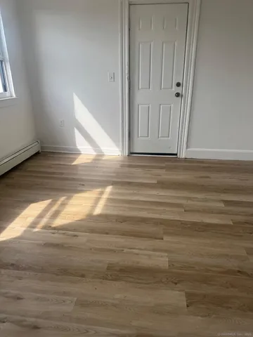 a view of a room with wooden floor