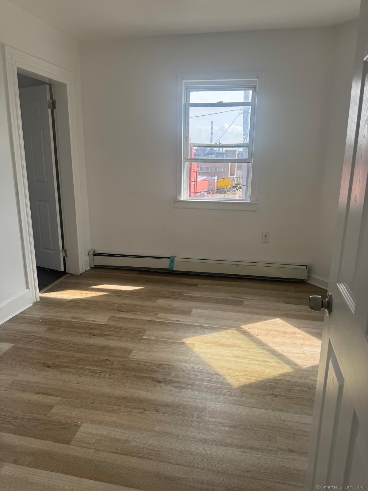 202 Noble Avenue, Unit 3 Bridgeport, CT 06608 - Photo 4 of 6 a view of a room with wooden floor
