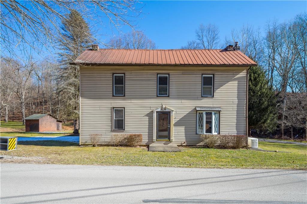 a view of a house with a yard and sitting area