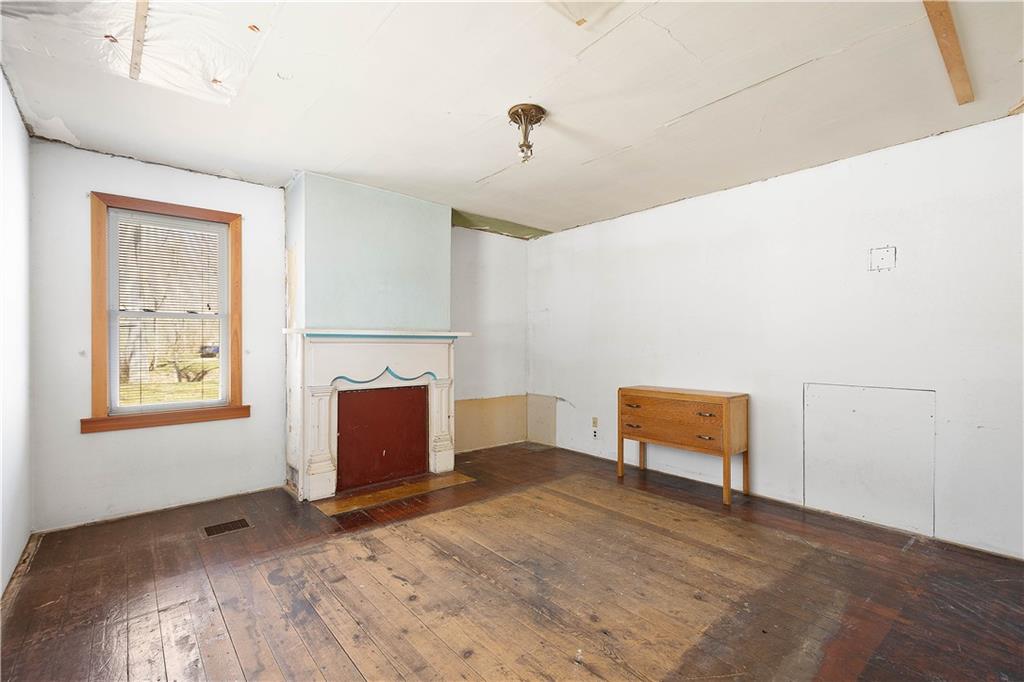 69 Pike Run Road Daisytown, PA 15427 - Photo 22 of 39 a bedroom with furniture and a fireplace