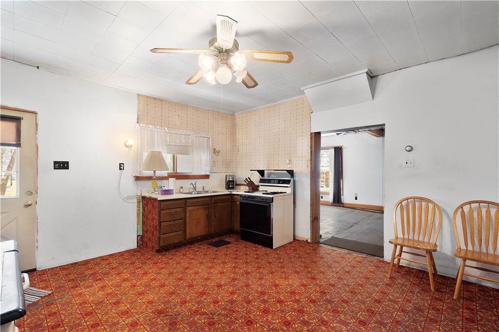 69 Pike Run Road Daisytown, PA 15427 - Photo 27 of 39 a kitchen with stainless steel appliances granite countertop a sink and cabinets