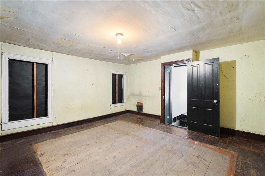 69 Pike Run Road Daisytown, PA 15427 - Photo 31 of 39 a view of an empty room with wooden floor