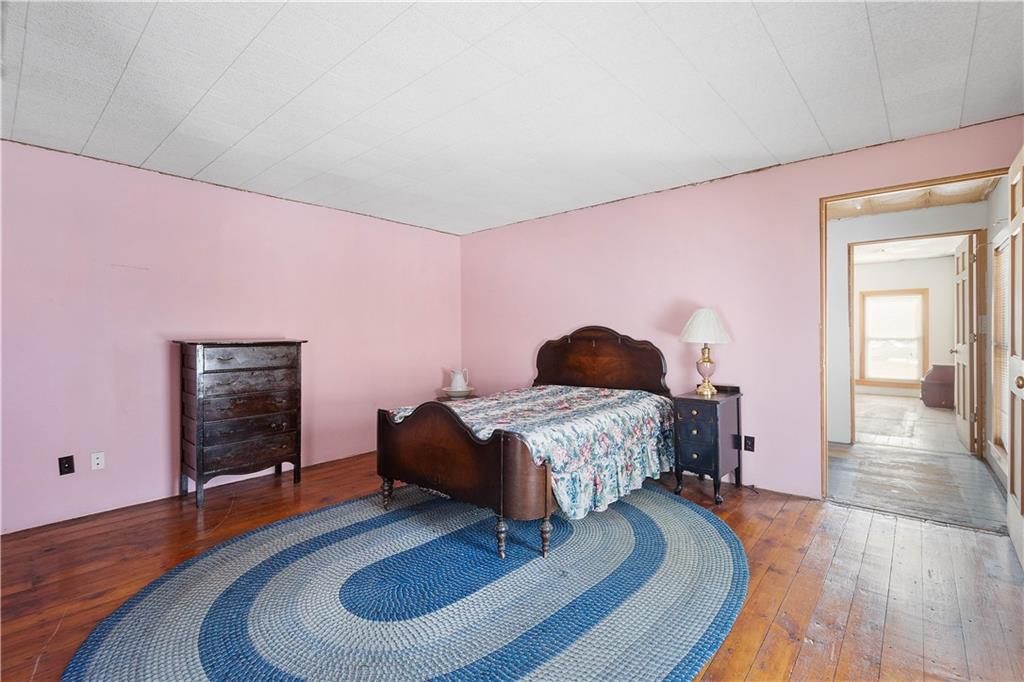 69 Pike Run Road Daisytown, PA 15427 - Photo 32 of 39 a bedroom with a bed and wooden floor