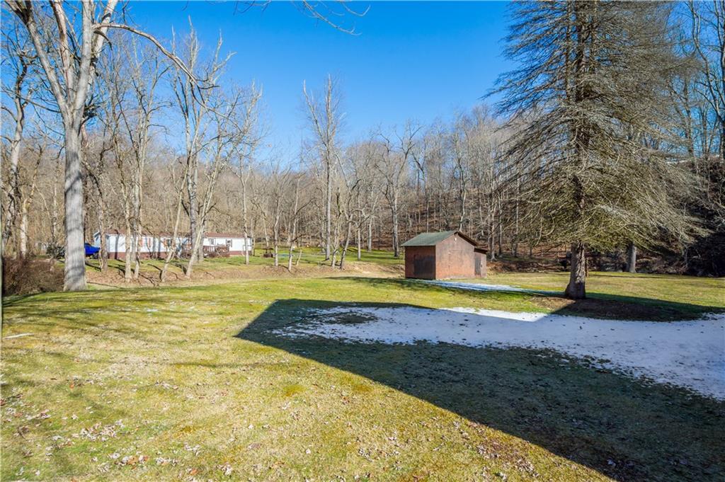 69 Pike Run Road Daisytown, PA 15427 - Photo 5 of 39 a view of swimming pool with lawn chairs and large trees