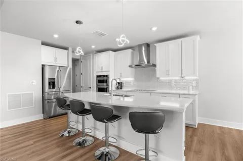 a kitchen with granite countertop a sink and a stove