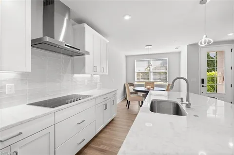 a dining room with furniture and wooden floor