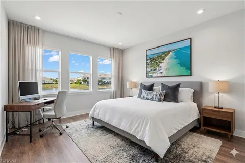 a large bed sitting in a bedroom next to a window