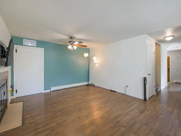 a view of a kitchen with wooden floor and a kitchen