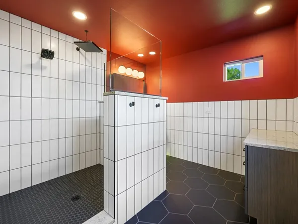 a bathroom with a shower and a sink
