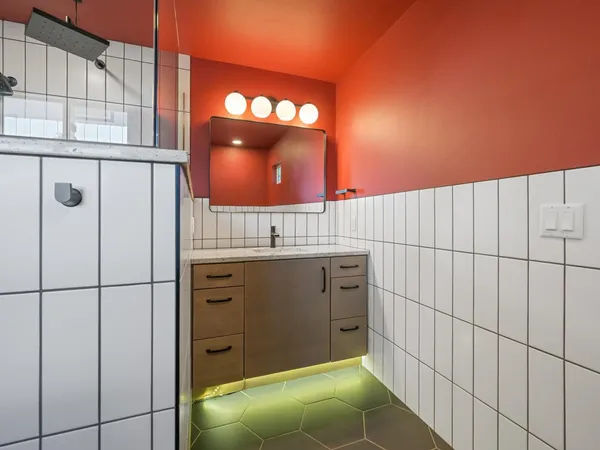 a bathroom with a sink a toilet and shower