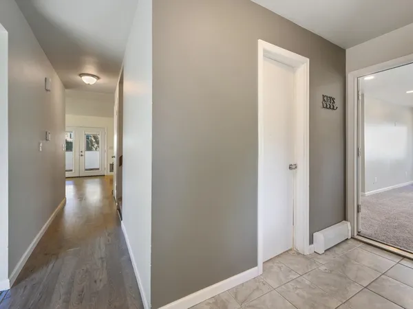 a view of a hallway with wooden floor
