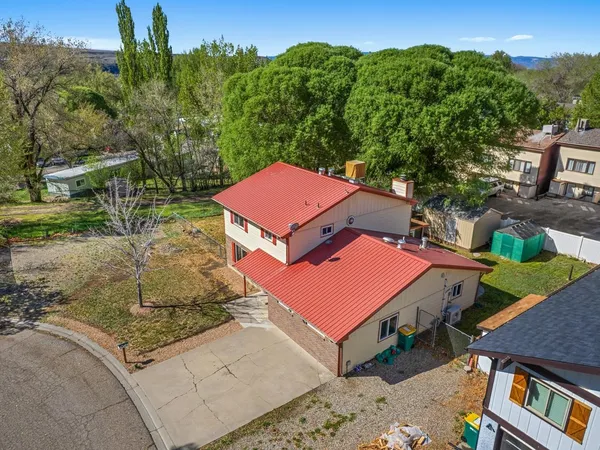 an aerial view of a house with a yard
