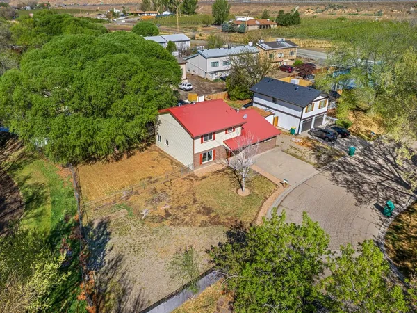 an aerial view of residential houses with outdoor space and river