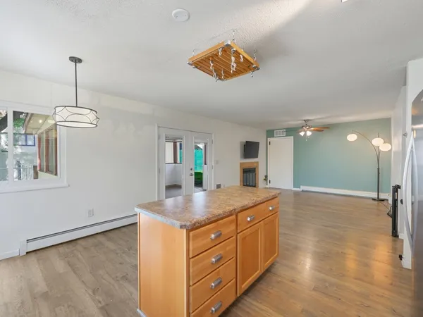 a kitchen with stainless steel appliances granite countertop a stove and cabinets