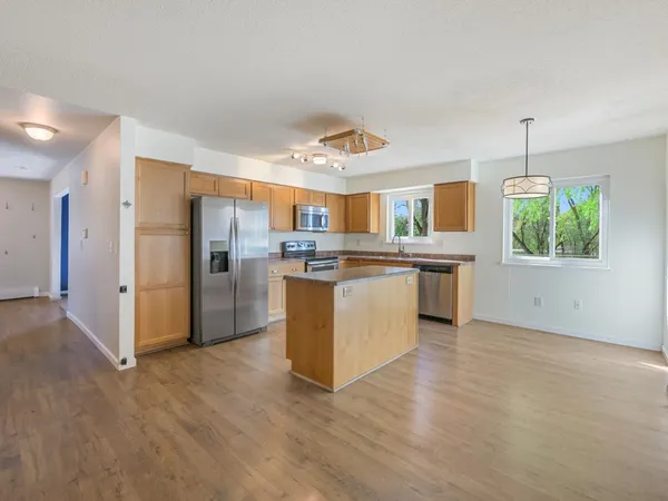 wooden floor fireplace and windows in an empty room
