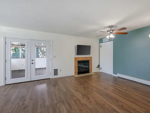 a view of an empty room with wooden floor