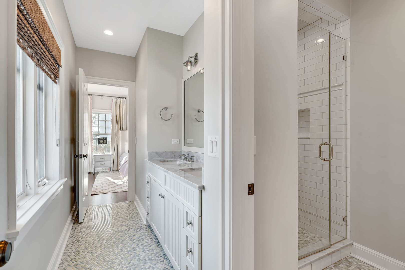 Undisclosed Address Winnetka, IL 60093 - Photo 23 of 41 a bathroom with a double vanity sink a toilet and a glass door shower