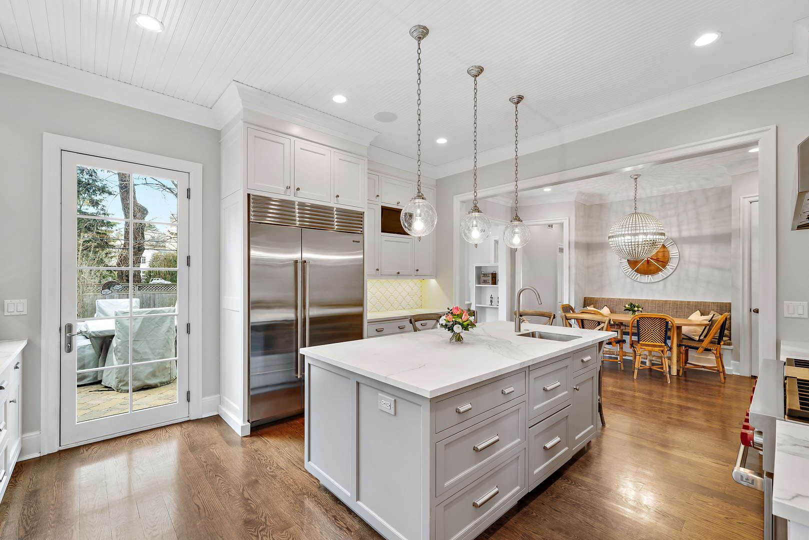 Undisclosed Address Winnetka, IL 60093 - Photo 8 of 41 a kitchen with a stove a refrigerator a sink a dining table and chairs with wooden floor