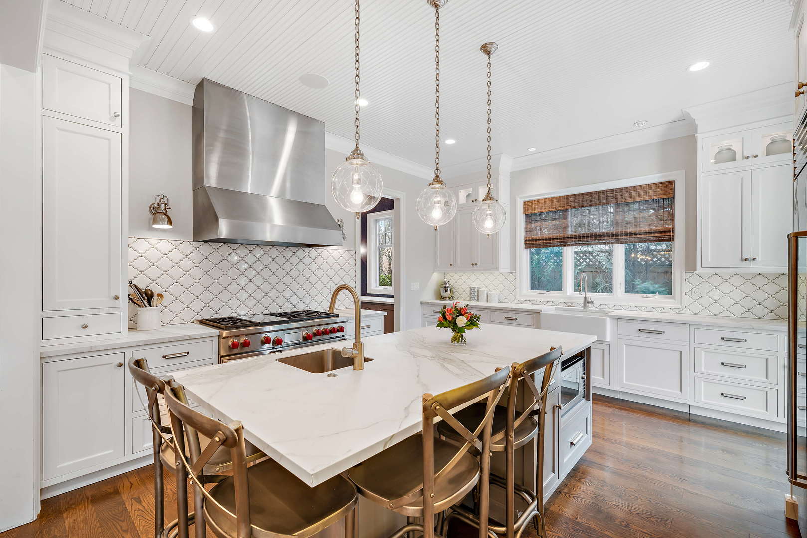Undisclosed Address Winnetka, IL 60093 - Photo 9 of 41 a kitchen with stainless steel appliances a table chairs and a wooden floor